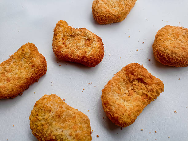 istock Appetizing fried chicken nuggets arranged neatly against a pure white background. 2216915999