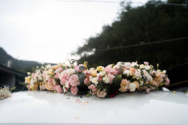 The flowers and couple's names on the wedding car