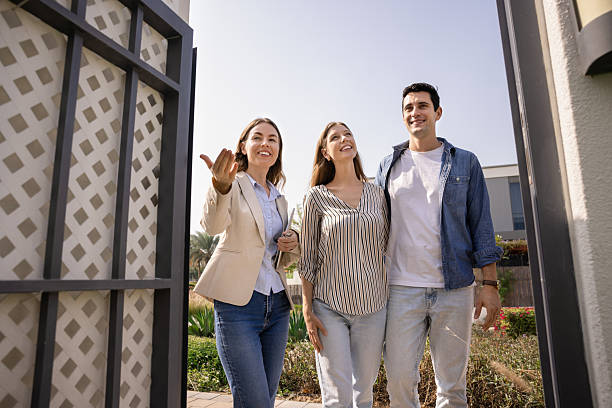 istock Positive real estate professional agent inviting renters to come 2216917606