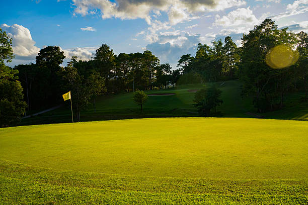 istock Beautiful golf course in a sunny day. Background evening golf course has sunlight shining down. 2216919711
