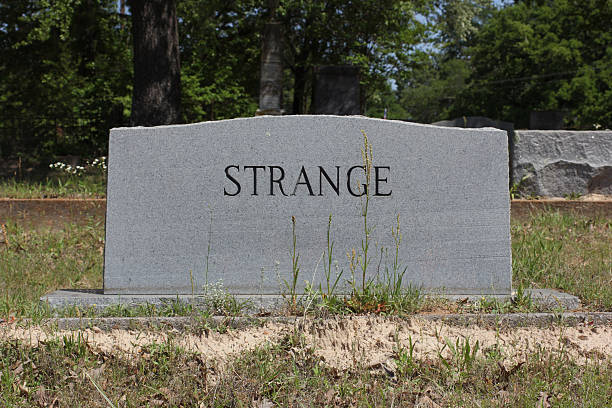 Headstone in Cemetery With Word Strange. Death Concept