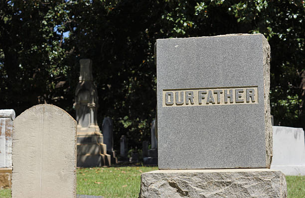 istock Words Our Father Engraved on Headstone Death Concept 2216925416