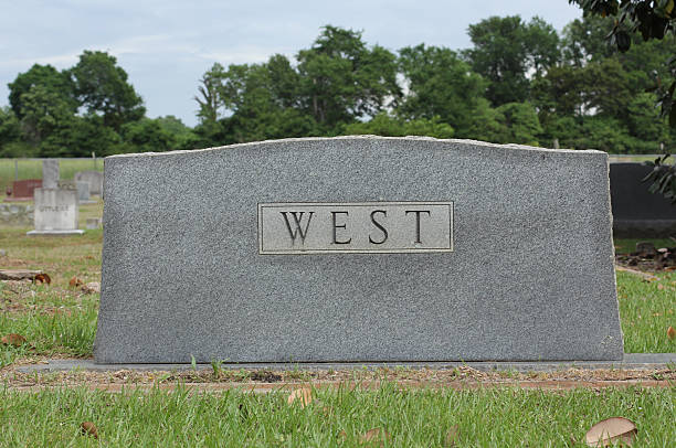 Close-up photograph of the word 'The' engraved on a textured, gray stone surface, showcasing the craftsmanship and typography in the engraving art with a weathered finish and a natural color texture.