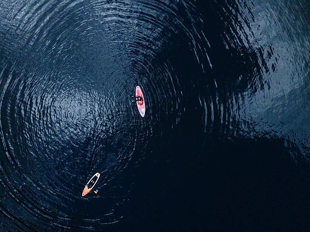 istock Aerial View of paddle boarders Exploring Serene Lake Waters 2216931085