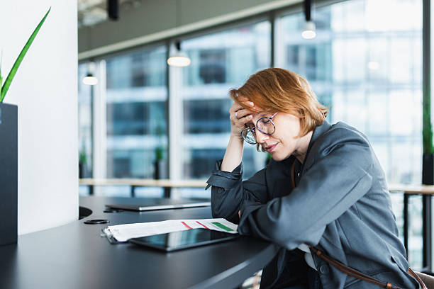 istock Business professional experiencing stress at the office desk with documents 2216931457