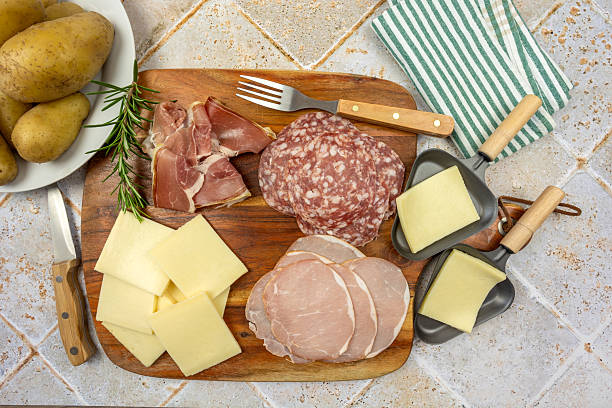 slices of raclette cheese and cold cuts on a table