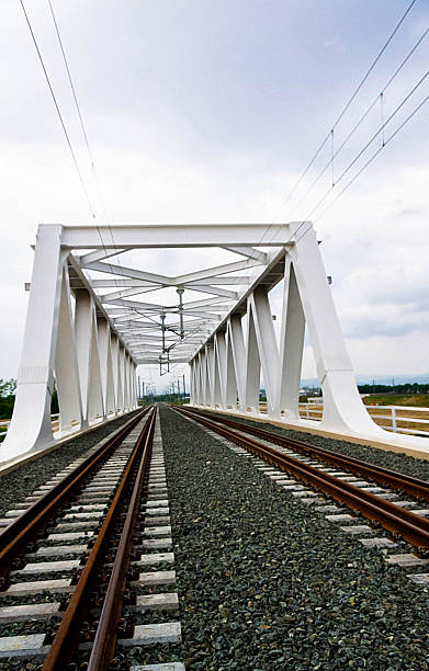istock Symmetrical View of Modern White Railway Bridge with Tracks 2216938177