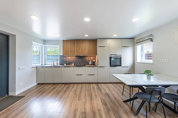 istock Modern Home Bright Kitchen and Dining Space with Stylish Wooden and White Cupboards 2216938815