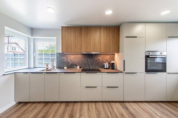 istock Modern Home Kitchen Interior with Wooden Cabinets and Large Bright Windows 2216938833