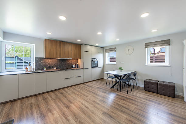 istock Modern Home Bright Kitchen and Dining Space with Stylish Wooden and White Cupboards 2216938895