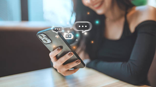 istock Happy user interacting with AI chatbot on smartphone – digital assistant concept, Artificial intelligence technology automatically responds to online messages to help customers instantly. 2216939500