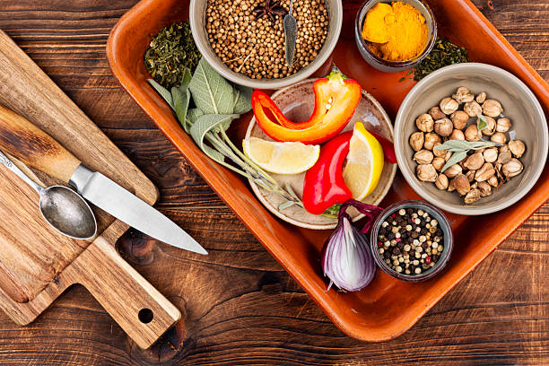 Pile of chopped parsley and chilli pepper on wooden board. Chopped green herbs and red pepper on cutting board. Healthy eating concept. Raw food background. Home cooking background.