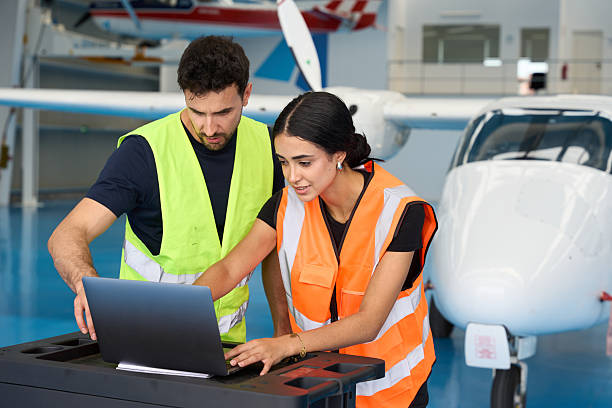 istock Aircraft mechanics using laptop for maintenance in hangar 2216943665