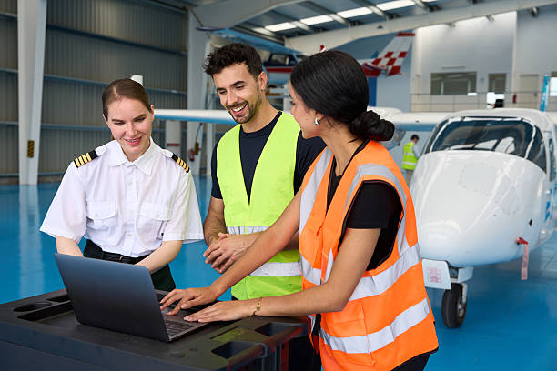 istock Aviation students and pilot collaborating on laptop in hangar 2216943670