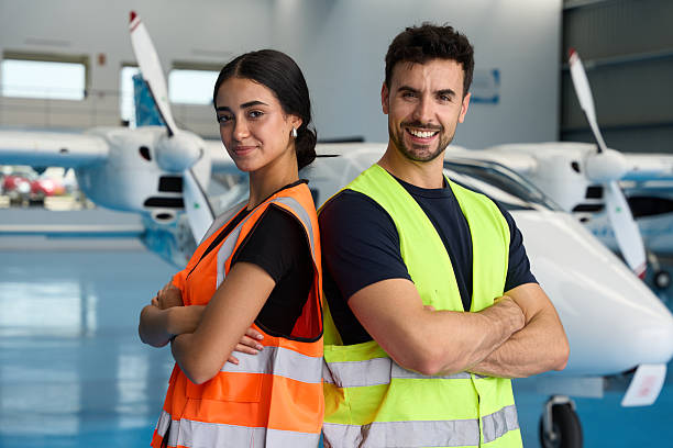istock Aircraft mechanics smiling at camera in hangar 2216943701