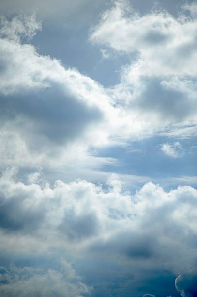 Nature background abstract photo of the beauty of the sky adorned with white, billowing cumulus clouds, creating an abstract texture against the vast expanse of bright blue. This panoramic view offers a captivating angle, showcasing the ethereal dance of clouds amidst the boundless sky. Immerse yourself in the tranquility of nature's canvas, where the interplay of light and shadow creates an ever-changing spectacle of wonder