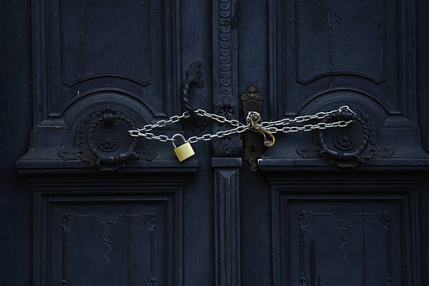 Antique dark color door closed on padlock with chain