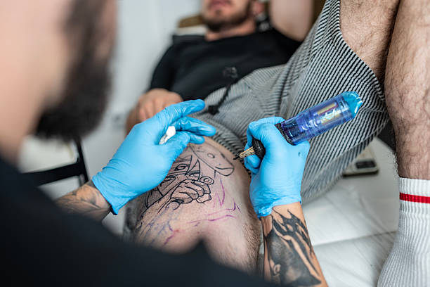 istock Tattoo Artist Working on Intricate Design on Client's Skin in Studio 2216946943