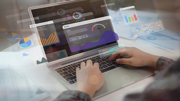 istock Close-up of hands using laptop with holographic data dashboard and analytics charts. Modern technology concept for big data analysis, business intelligence, and digital transformation. 2216951477