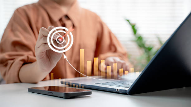 istock Business person aiming at target with growth chart, symbolizing goal setting, marketing strategy, KPI planning, and successful business performance in data-driven digital economy. 2216951484