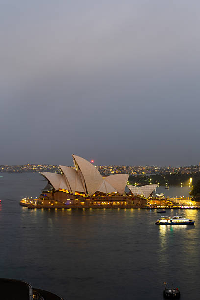 Sydney, Australia - May 23, 2025: Cloudy dusk view of Sydney Opera House.