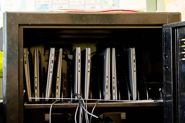 istock Laptop charging cart in an elementary school classroom with organized portable computers for classroom technology management and digital learning 2216952415