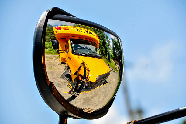 A school bus travels down a country road on its morning pickup route.
