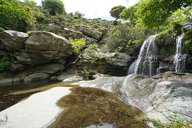 istock Small Waterfall in Lush Forest on Andros Island, Greece 2216952801