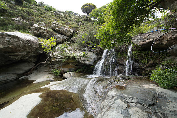 istock Small Waterfall in Lush Forest on Andros Island, Greece 2216952959
