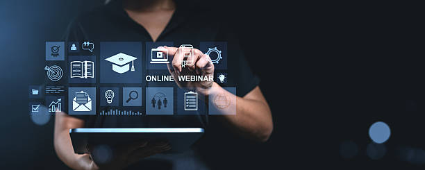 istock Woman interacting with online webinar interface on digital tablet screen in dark room. 2216954620