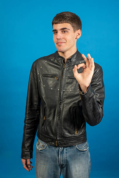 istock Young man showing ok sign with hand and smiling 2216954738