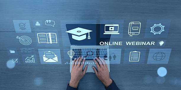 istock Online education concept with webinar icons and hands typing on laptop keyboard. 2216955958