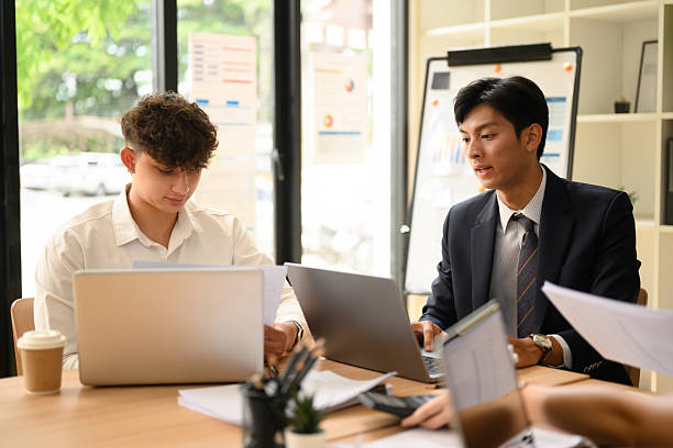 istock Team of Diverse Business People Discussing Reports in Modern Office 2216957087