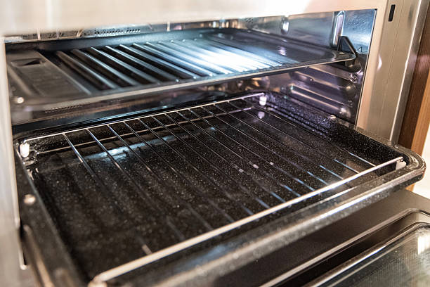 Close-up of oven rack and tray in stainless electric oven