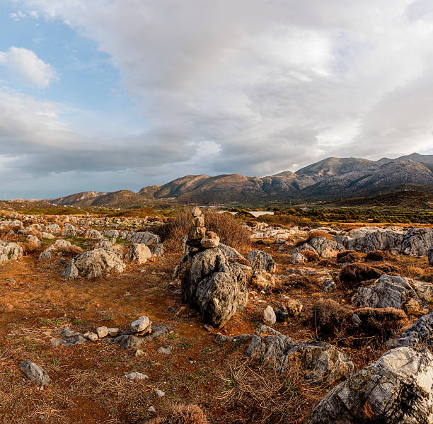 Golden light shines on Malia's rugged terrain, showcasing the beauty of Crete's rocky landscape and mountains.