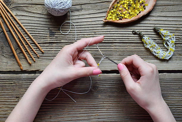 istock Flat lay of crochet tools and materials for making a bracelet with beads  detailed step of needlework, threadwork and jewelry design  creative handmade work and income from home 2216961896