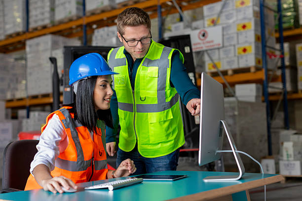 istock Young Male and Female Warehouse Workers Collaborating on a Computer in a Warehouse 2216964793