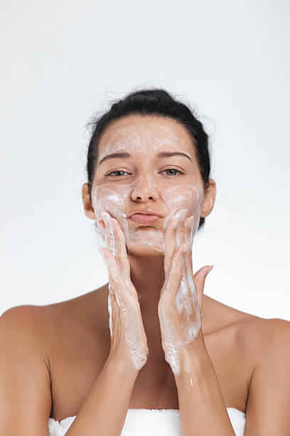 istock Playful Woman Making a Funny Face While Washing Her Face 2216971166