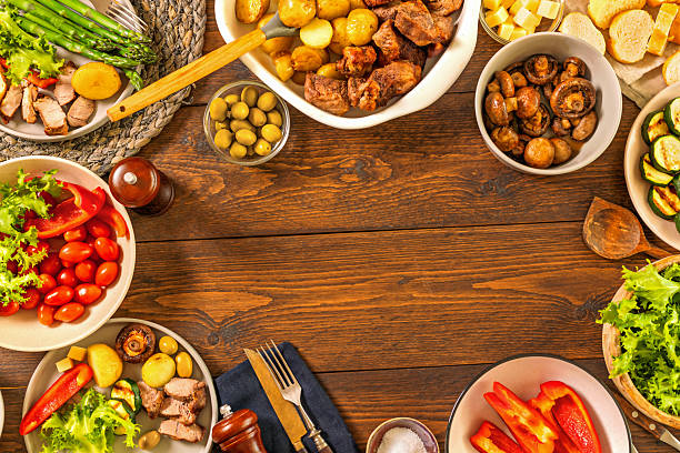 istock Family dinner table with meat potatoes vegetables 2216971535