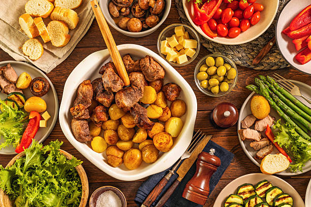 istock Family dinner table with meat potatoes vegetables 2216971544