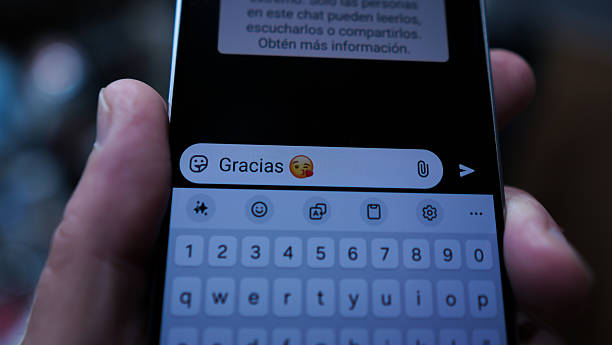 istock Text Thank you with text emoticon typed on a smartphone in a messaging app 2216975407
