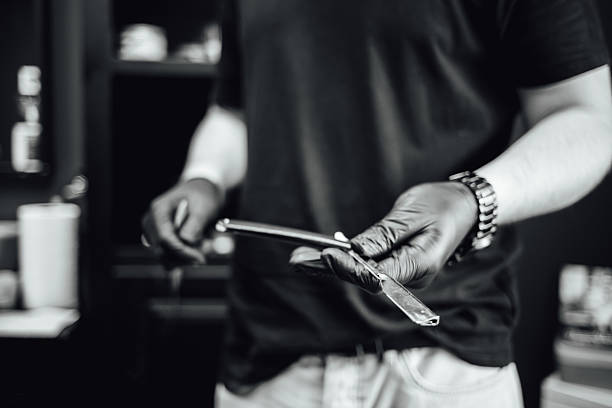 An older man shaves, preparing for work