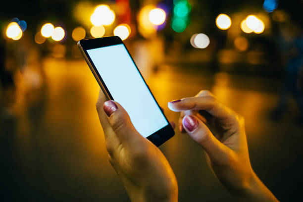 istock A woman is holding a cell phone and texting 2216976340