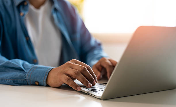 istock Close-up A hands man typing keyboard of laptop computer communicates on internet technology with paperwork on office desk. Workplace, Businessman professional busy working on new job project idea. 2216978116