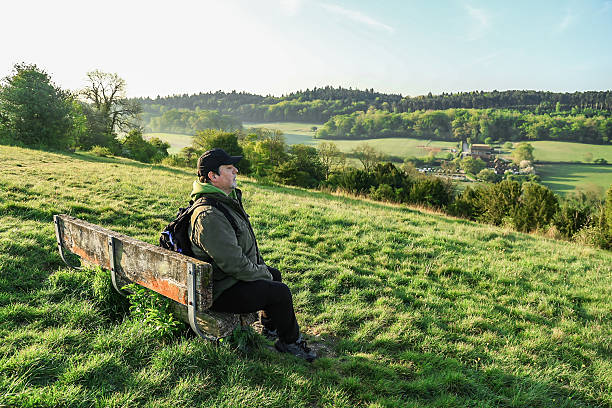 istock A lonely man sitting on the bench looking at the view Surrey England 2216980269