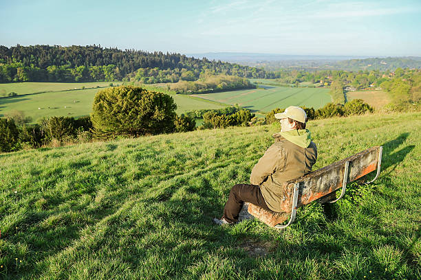 istock A lonely man sitting on the bench looking at the view Surrey England 2216980270