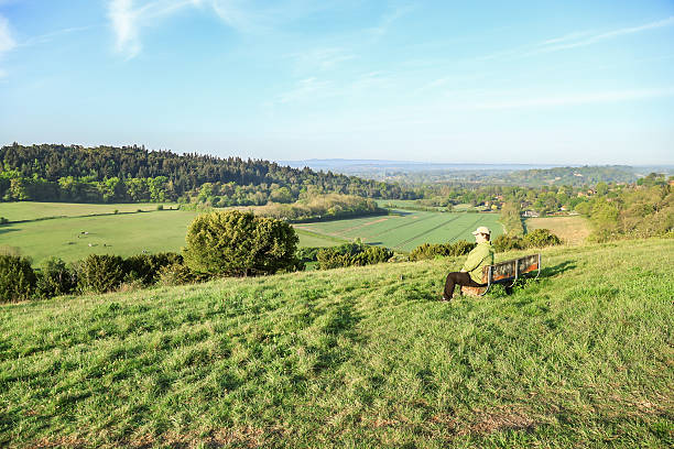 istock A lonely man sitting on the bench looking at the view Surrey England 2216980284