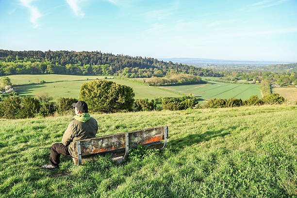 istock A lonely man sitting on the bench looking at the view Surrey England 2216980287