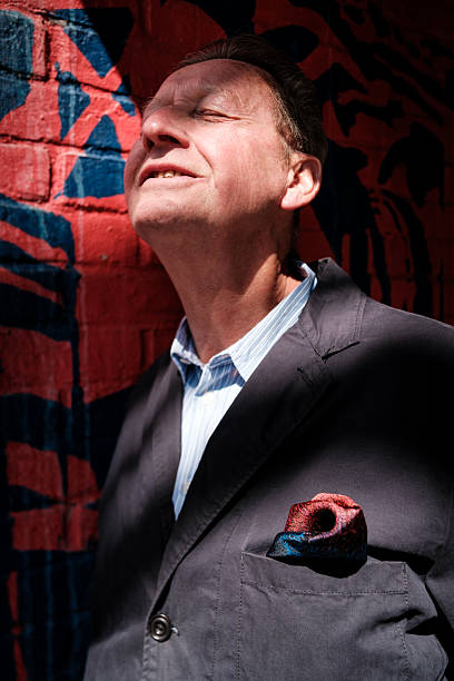 Senior businessman enjoying sunlight with eyes closed