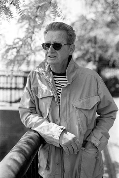 istock Senior man leaning on railing in black and white analog photo 2216981582